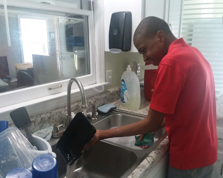 Malik washing dishes.