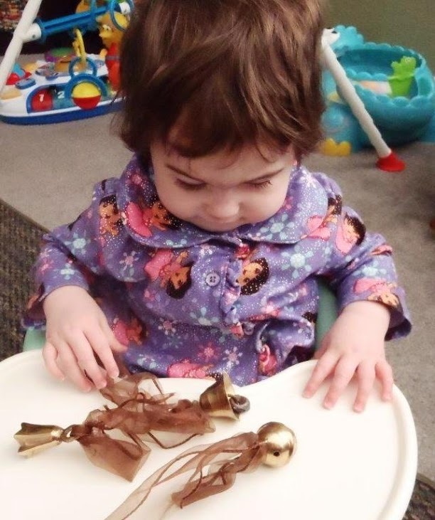 A child plays with bells.