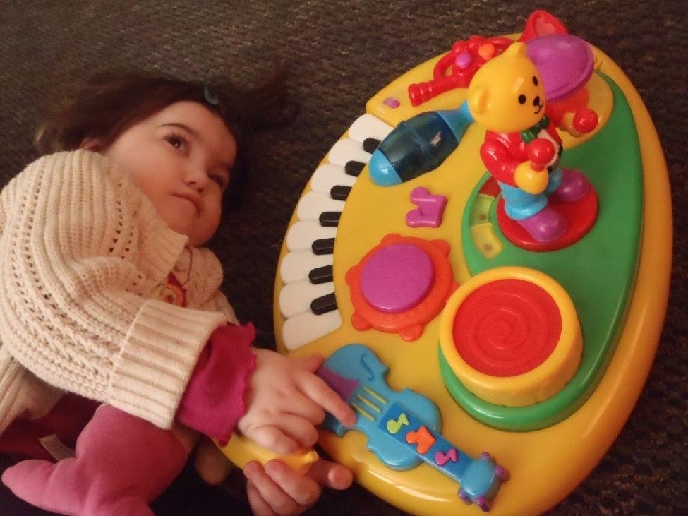 A child plays with a musical toy.