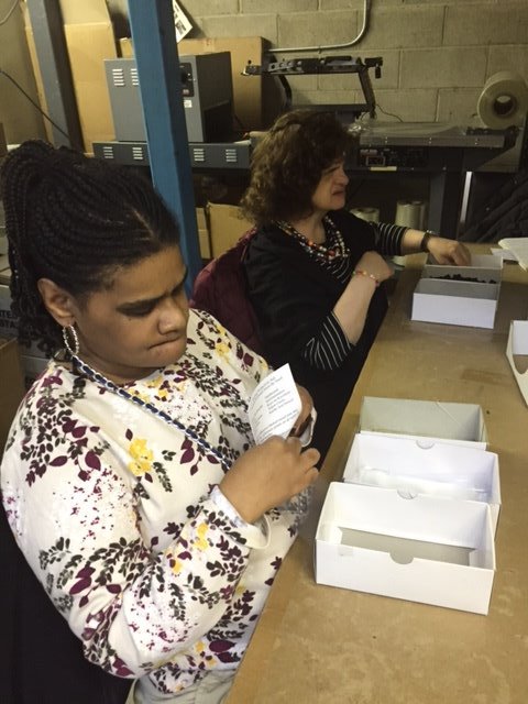 Linda and Damali stuffing envelopes.