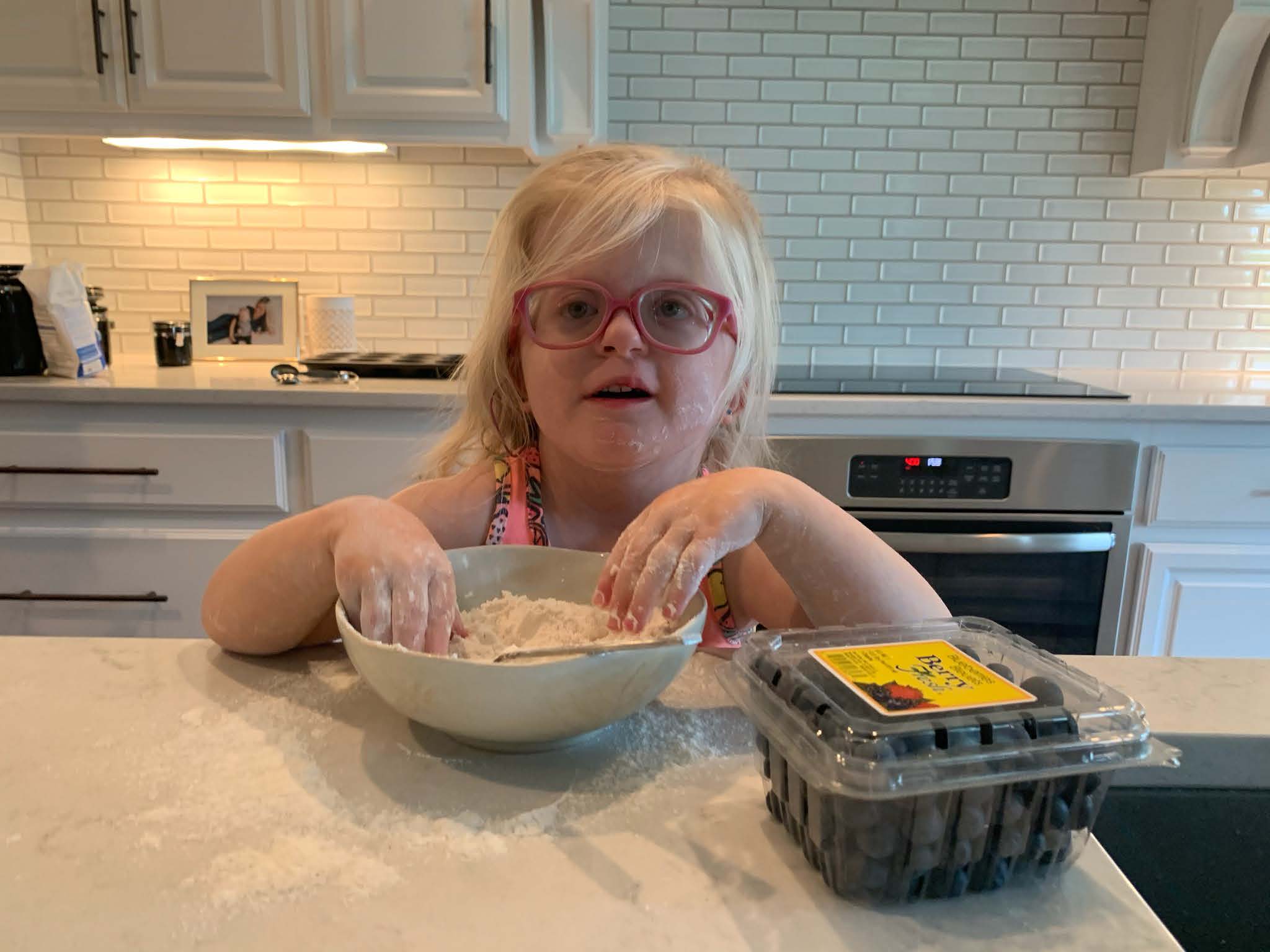 Jackie mixing dry ingredients in a bowl with her hands.