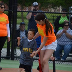 There is a child with a support person playing sports