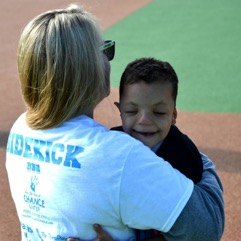 There is a blonde woman with a white shirt hugging Devin