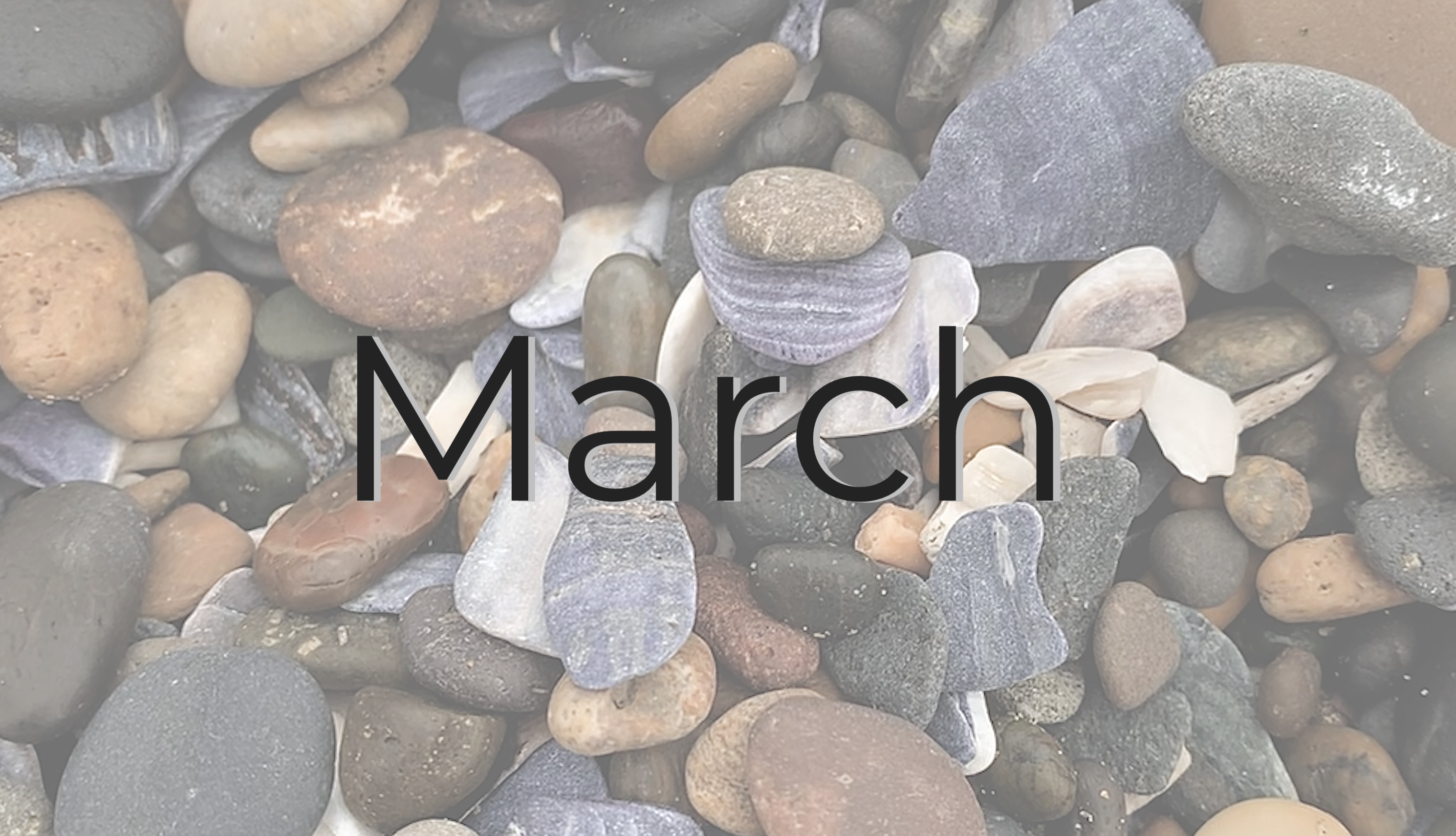 Pebble rocks with the word March in center.