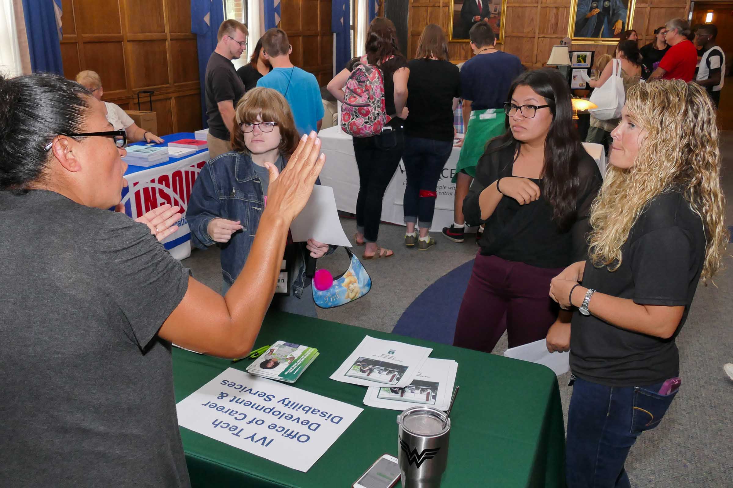 Young adult at exhibition table.