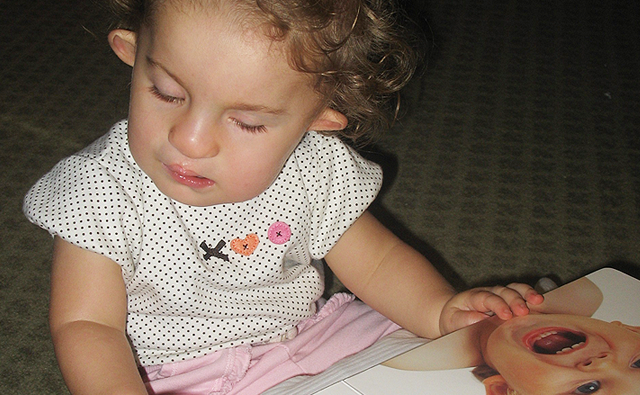 Young child looking at a book.